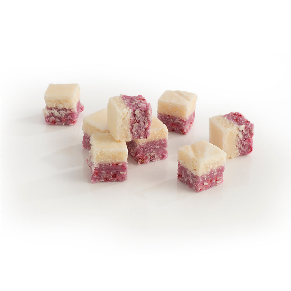 Close-up of the pink and white layers of Raspberry Coconut Ice, blending tangy raspberry and creamy coconut.