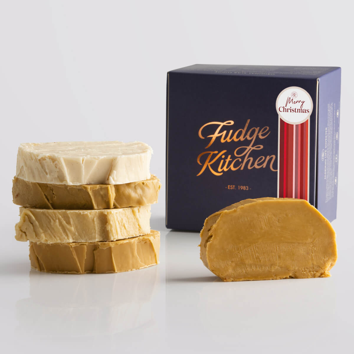 Fudge Kitchen Caramel and Cream Fudge Selection presented in an indigo gift box and Happy Christmas decorative seal