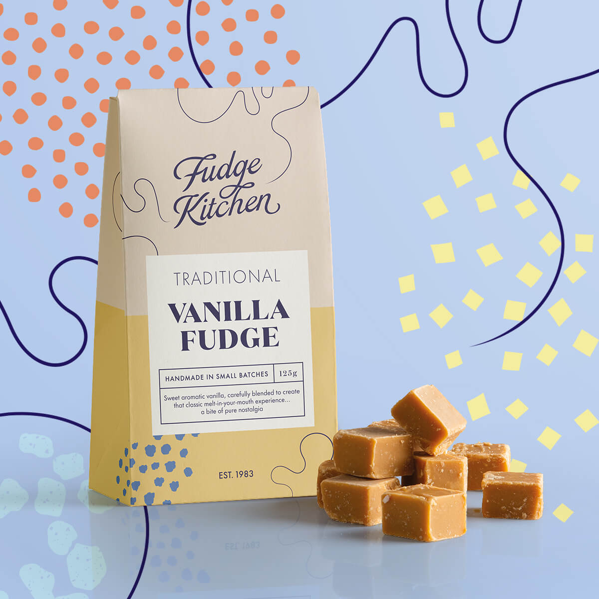 Traditional Vanilla Fudge in its pack, with golden fudge squares displayed beside it with decorative swirls in the background.