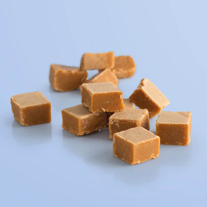 Traditional Vanilla Fudge in its pack, with golden fudge squares displayed beside it. A classic, crumbly treat bursting with buttery flavour.