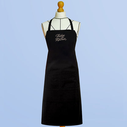 Fudge Kitchen Apron, a stylish and practical apron featuring the Fudge Kitchen logo. Perfect for home bakers and fudge lovers who enjoy making sweet treats in the kitchen.