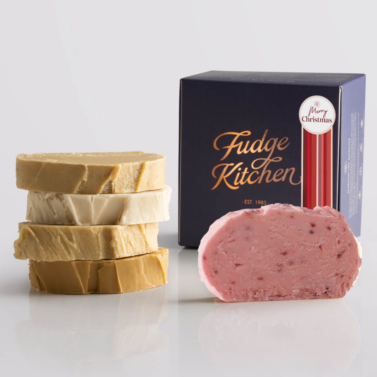 Toffee fudge and fruit fudge selection presented in an indigo gift box and Merry Christmas decorative seal.