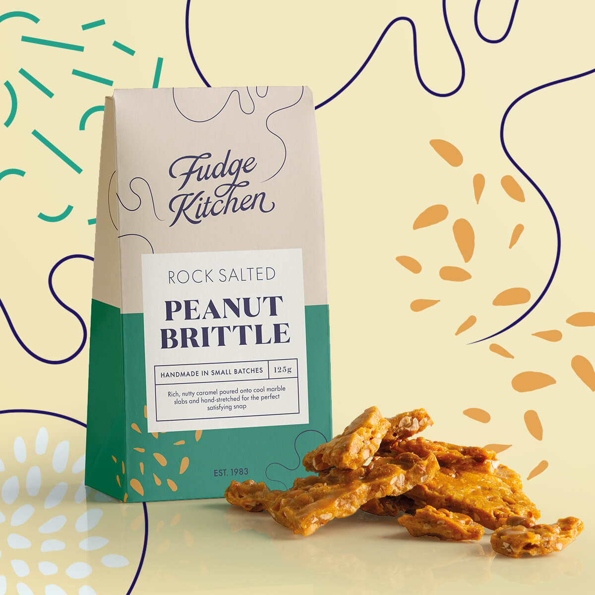 Rock Salted Peanut Brittle in its pack, with rich caramel brittle pieces displayed alongside with decorative swirls in the background.