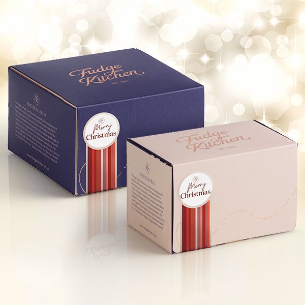 Buff-coloured 3-slice fudge gift box and indigo 5-slice fudge gift box, each adorned with a festive 'Happy Christmas' seal. Perfect for seasonal gifting.