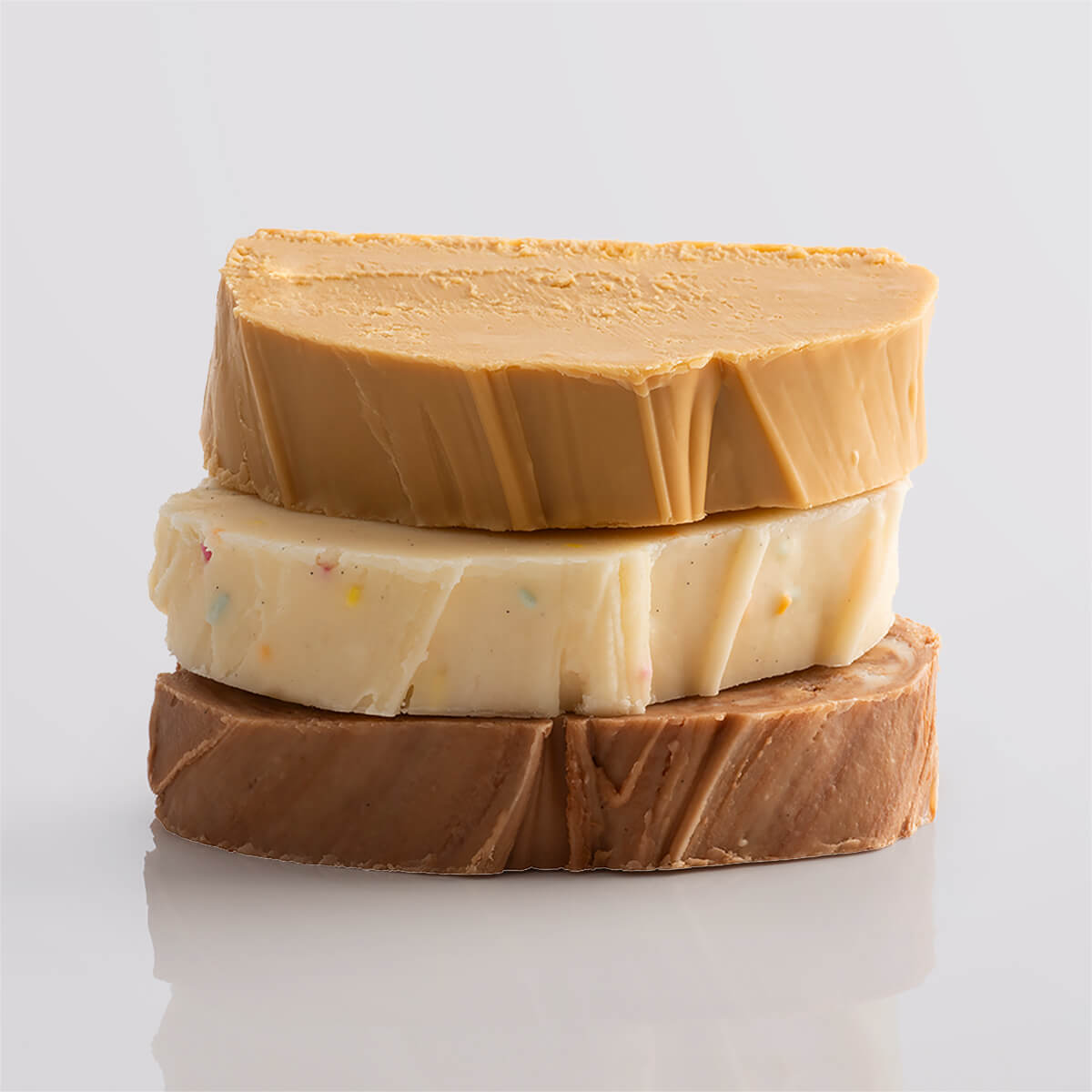 A stack of vibrant fudge slices in a variety of textures and colours.