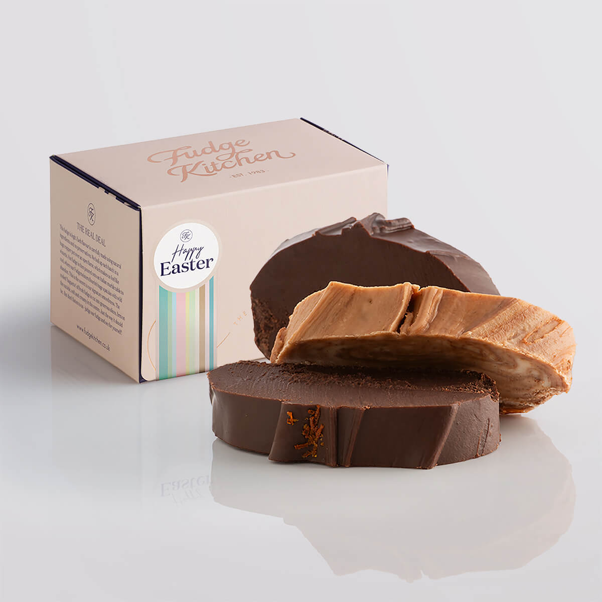 Chocolate fudge slices elegantly displayed in a buff-coloured gift box with gilded accents and a Happy Easter box seal.