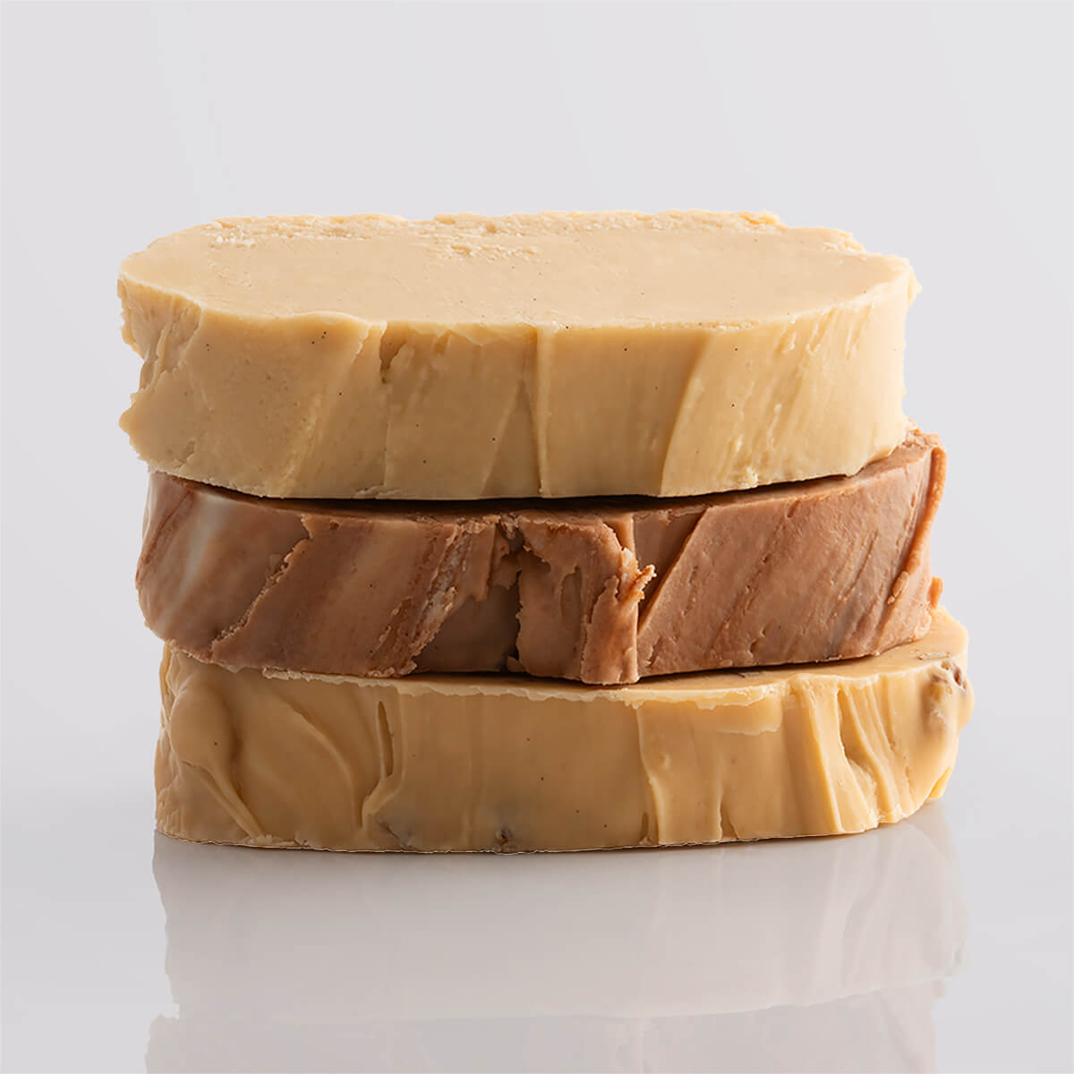 A stack of classic fudge slices showcasing a variety of rich and creamy textures.