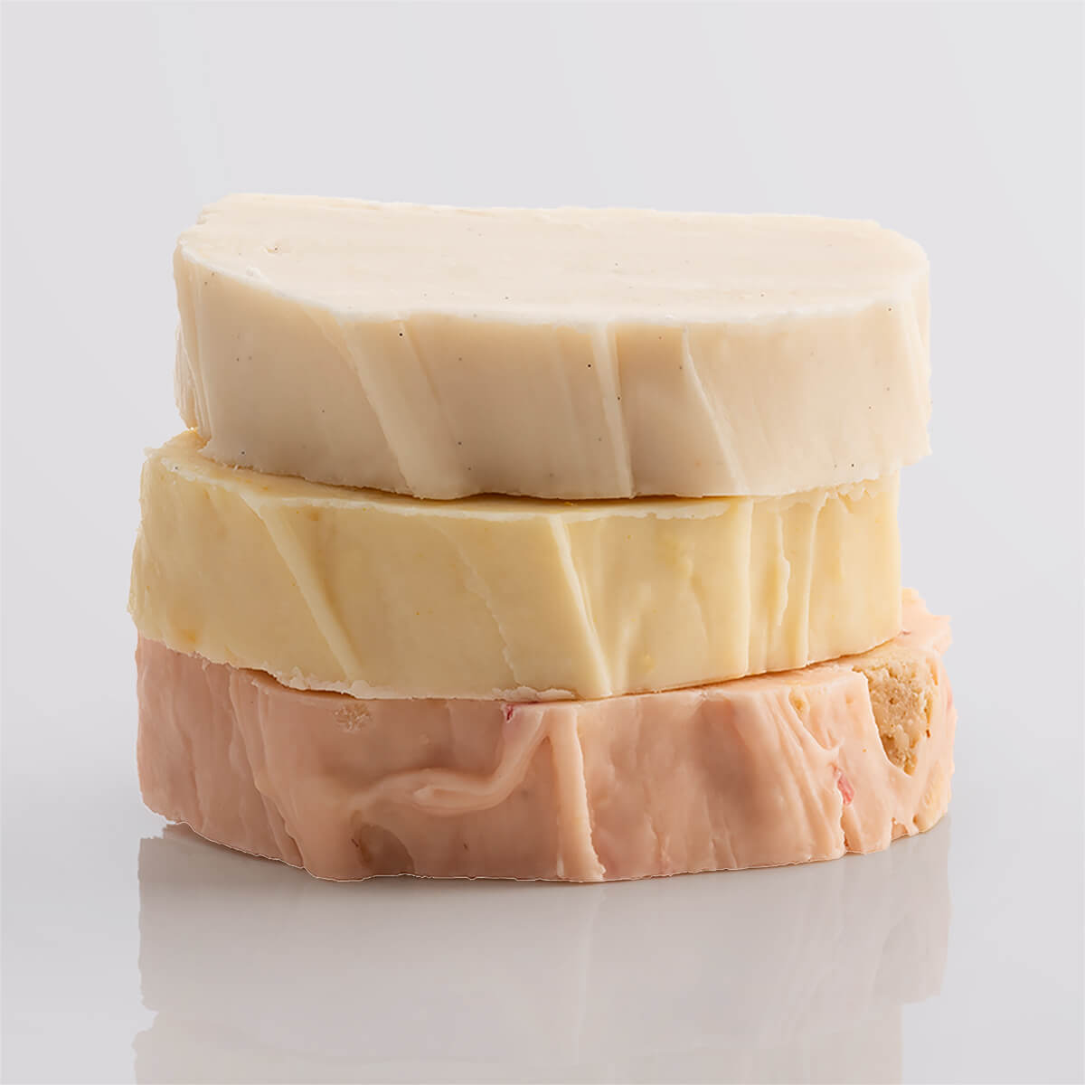 A stack of fudge slices in bright, fruity tones highlighting their light textures