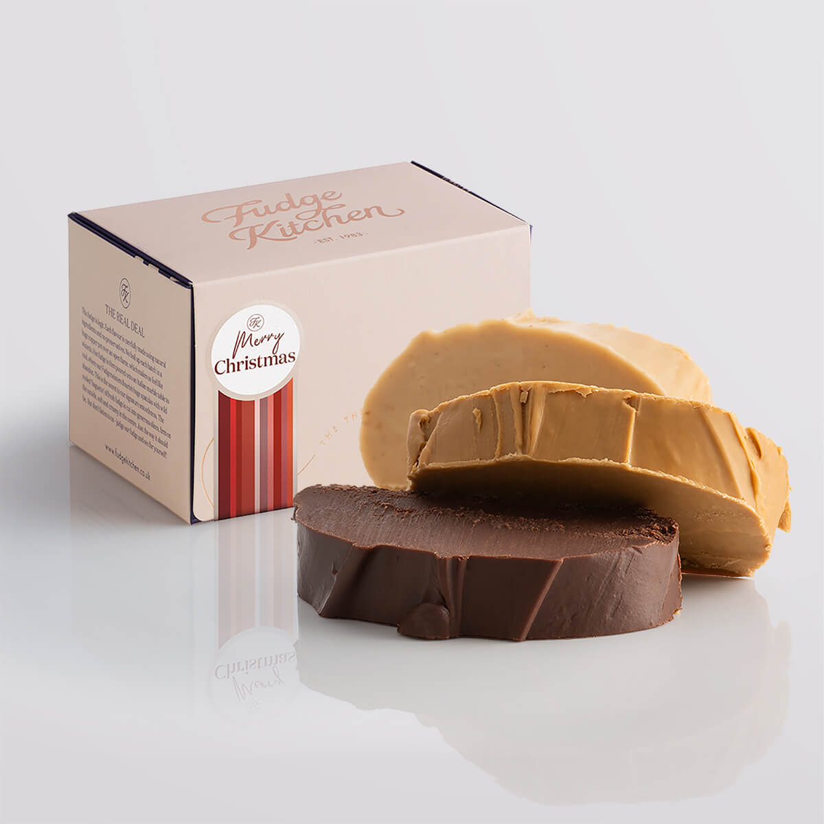 Nut-free fudge trio packaged in a buff-coloured gift box with gilded accents and a 'Merry Christmas' box seal.