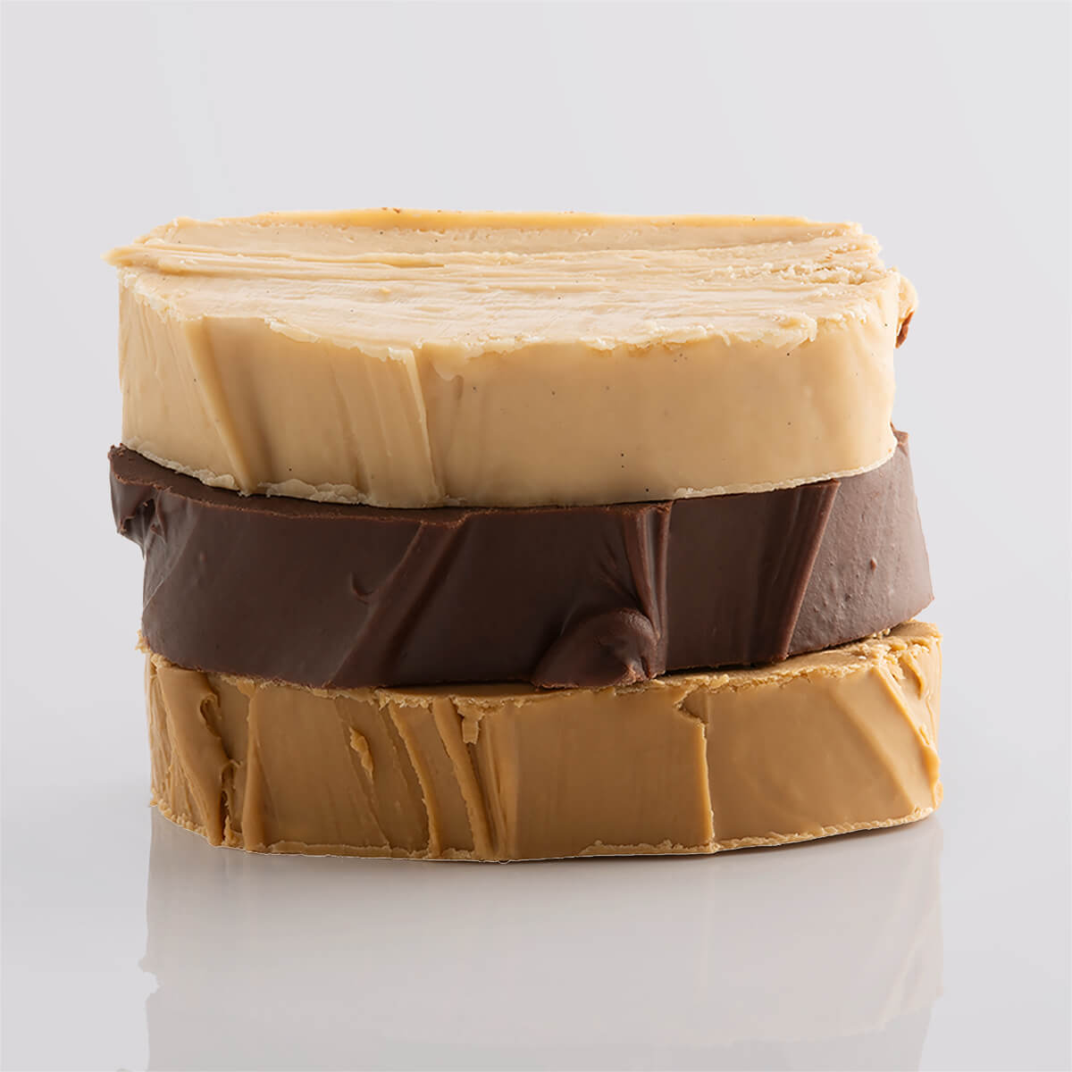 A stack of nut-free fudge slices in rich tones with a smooth texture