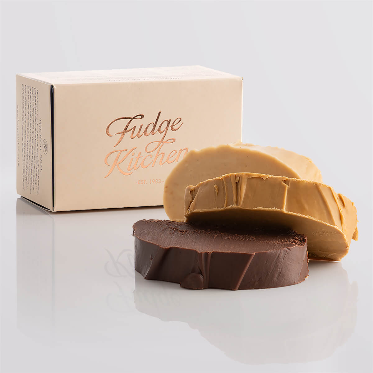 Nut-free fudge trio packaged in a buff-coloured gift box with gilded accents.