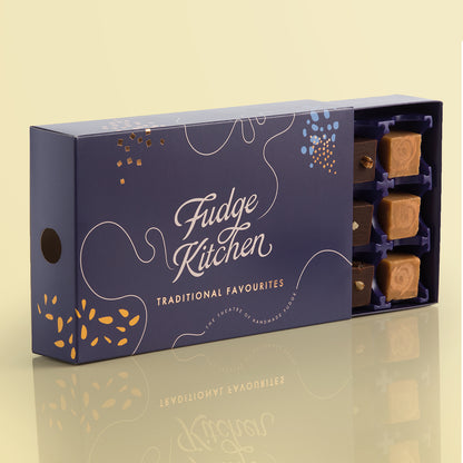 Traditional Favourites Fudge Selection by Fudge Kitchen open box, showcasing 15 smooth, creamy fudge pieces in a variety of timeless flavours like vanilla, toffee, and chocolate.