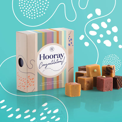 Fudge Kitchen Afternoon Tea Fudge Selection, elegantly presented in a box with nine delicious fudge pieces shown, with a Congratulations sleeve. Includes a variety of afternoon tea-inspired flavours, perfect for gifting or indulging.