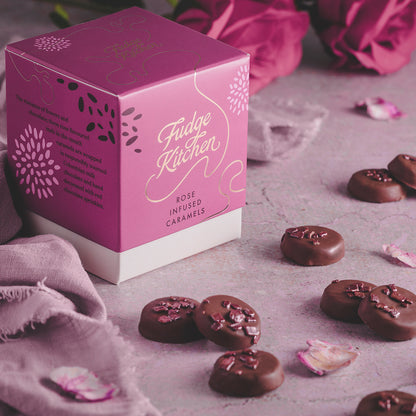 Rose Infused Caramels by Fudge Kitchen, served as a luxurious, floral indulgence in a table setting with a box. Perfect for gifting or enjoying as a refined treat.